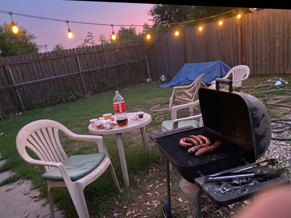 A backyard grill at dusk, the kind of photo people send in a chat.